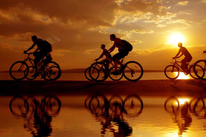 cyclists on beach